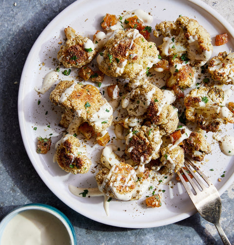 From Flavors of the Sun: Warm Roasted Cauliflower with Tahini-Yogurt Dressing